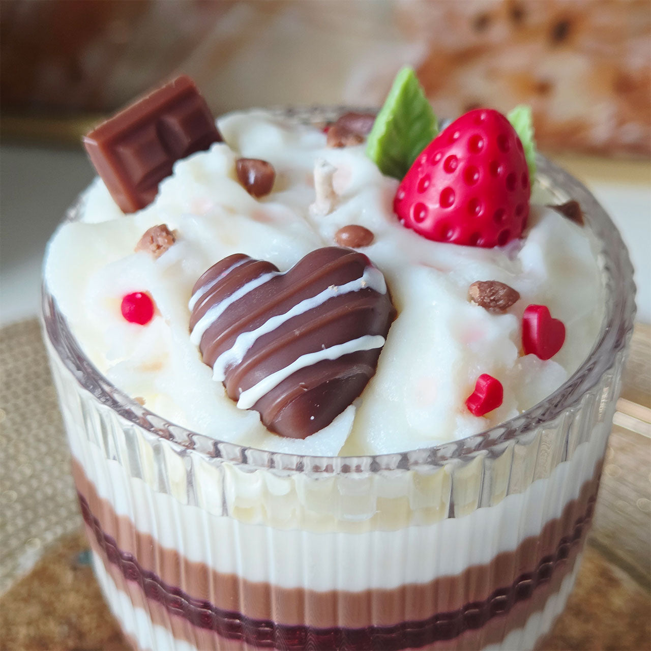 Detailaufnahme der Schokoladen- und Erdbeerschicht einer Dessert-Duftkerze