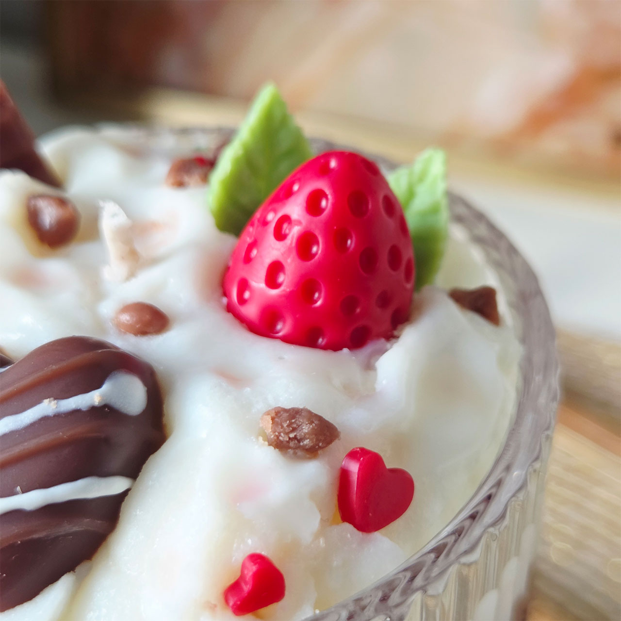 Detailansicht einer mehrschichtigen Dessertkerze mit Schokoladen- und Erdbeerakzenten
